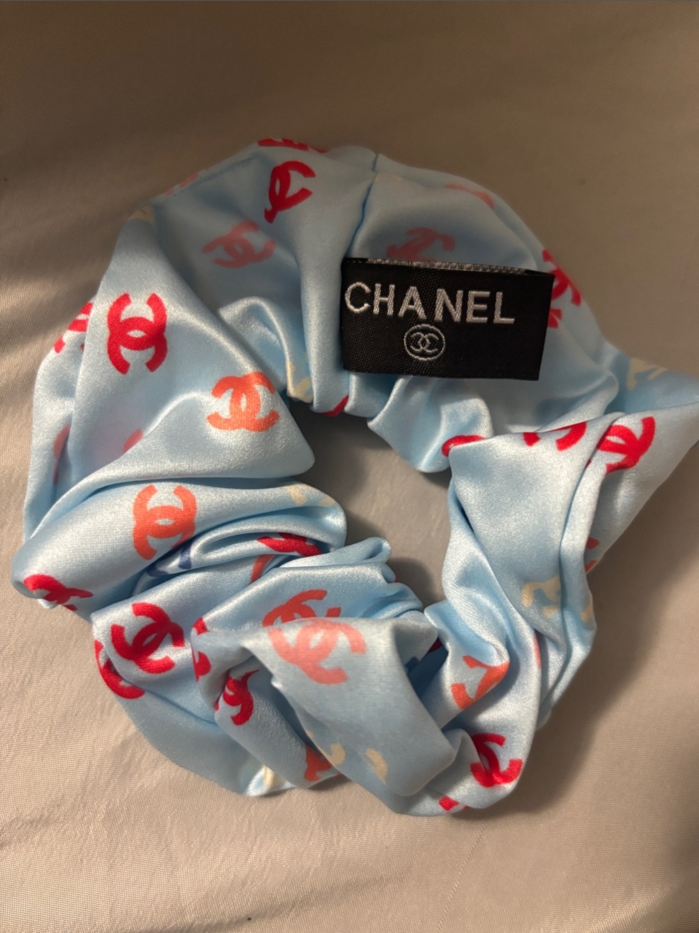 CHANEL Light Blue Satin Scrunchie with Red and Coral Logos